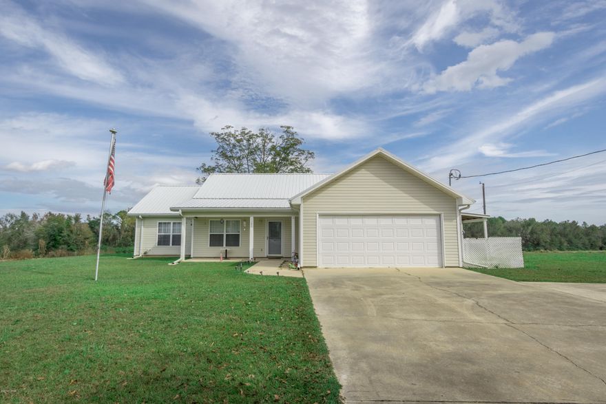 Looking for nice home on acreage... look no futher!!! This 3 bedroom, 2 bath home with office (has closet and could be 4th bedroom) with large Florida Room. Kitchen is open to dining/living area with breakfast bar. Home has standby generator with propane tank and security system. two large outbuildings, 25x40 with garage door and electric with lights. 2nd outbuilding 20x30 with electric and lights. 12x20 Boat/car covering detached. Home and outbuildings have new metal roofs. Majority of land is being farmed or easily could be used for horse or cows.