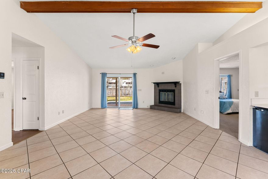 Welcome to this charming 3-bedroom, 2-bathroom single-family home in the desirable North Lagoon area of Panama City Beach, Florida. This inviting residence offers comfortable coastal living, just minutes from the beautiful white-sand beaches, Lagoon, golf courses, local dining, and exciting attractions.

Step inside to find a spacious main living area with a cozy fireplace as the centerpiece, accented by high ceilings with exposed wooden beams, a ceiling fan, and plenty of natural light from multiple windows. The tile flooring provides an easy-care, beach-friendly surface that flows seamlessly from the living room into the dining area and kitchen--creating a practical, connected layout ideal for everyday living and entertaining.

The kitchen offers ample cabinetry and flows naturally into the living and dining spaces, making it easy to stay connected while preparing meals or hosting gatherings. An attached garage offers room for cars, boats toys and storage with extra space for a shop area and more. 

The large master bedroom is just one of the three generously sized bedrooms. The master features an ensuite bathroom with another large closet that could also be used for laundry. Two additional bedrooms and a full bathroom in the hallway provide ample space for family or guests.

Step outside to enjoy the Florida sunshine on the covered patio, perfect for relaxing with morning coffee or evening breezes. The fully fenced backyard delivers privacy and space for pets, play, or outdoor activities, with a practical storage shed for tools, beach equipment, or seasonal items. A two-car garage adds secure parking and extra storage.

Located in a peaceful, established neighborhood with low HOA fees of just $255 per year, this home offers an affordable way to enjoy Panama City Beach's relaxed lifestyle. Whether you're looking for a primary residence, vacation retreat, or smart investment, this move-in-ready property combines classic charm with everyday functionality.

Don't miss out--schedule your showing today!