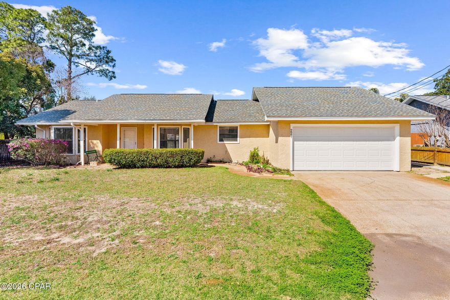 Welcome to this charming 3-bedroom, 2-bathroom single-family home in the desirable North Lagoon area of Panama City Beach, Florida. This inviting residence offers comfortable coastal living, just minutes from the beautiful white-sand beaches, Lagoon, golf courses, local dining, and exciting attractions.

Step inside to find a spacious main living area with a cozy fireplace as the centerpiece, accented by high ceilings with exposed wooden beams, a ceiling fan, and plenty of natural light from multiple windows. The tile flooring provides an easy-care, beach-friendly surface that flows seamlessly from the living room into the dining area and kitchen--creating a practical, connected layout ideal for everyday living and entertaining.

The kitchen offers ample cabinetry and flows naturally into the living and dining spaces, making it easy to stay connected while preparing meals or hosting gatherings. An attached garage offers room for cars, boats toys and storage with extra space for a shop area and more. 

The large master bedroom is just one of the three generously sized bedrooms. The master features an ensuite bathroom with another large closet that could also be used for laundry. Two additional bedrooms and a full bathroom in the hallway provide ample space for family or guests.

Step outside to enjoy the Florida sunshine on the covered patio, perfect for relaxing with morning coffee or evening breezes. The fully fenced backyard delivers privacy and space for pets, play, or outdoor activities, with a practical storage shed for tools, beach equipment, or seasonal items. A two-car garage adds secure parking and extra storage.

Located in a peaceful, established neighborhood with low HOA fees of just $255 per year, this home offers an affordable way to enjoy Panama City Beach's relaxed lifestyle. Whether you're looking for a primary residence, vacation retreat, or smart investment, this move-in-ready property combines classic charm with everyday functionality.

Don't miss out--schedule your showing today!