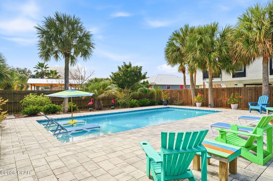 LOCATION!  LOCATION!  LOCATION!  This fabulous double-lot resort home with a pool is perfectly situated on South Lagoon in the heart of Panama City Beach's highly desirable east end. Just a short walk to the World's Most Beautiful Beaches and Grand Lagoon, this prime location also offers 2 nearby boat ramps with lagoon access to the Gulf.  This inviting, one-of-a-kind custom beach home features soaring 16-foot ceilings in the living room, beautiful LVP flooring, coastal colors, shiplap accents, three spacious bedrooms, stainless steel appliances, and granite countertops. Outdoor living truly shines with multiple entertaining spaces, a pool added in 2021, and a brand-new relaxing hot tub.     
The possibilities are endless...use as a primary residence, a relaxing personal resort, a high-performing vacation rental, or divide the lots and build on the second parcel. Additional features include a standing-seam metal roof, a two-car garage, a separate storage shed, and a private well for the sprinkler system. Located in a golf-cart-friendly neighborhood with no HOA, you'll enjoy easy access to the beach, Grand Lagoon, St. Andrews State Park, boating, dining, and entertainment. Call today to make this exceptional property your primary home, vacation getaway, or investment opportunity!