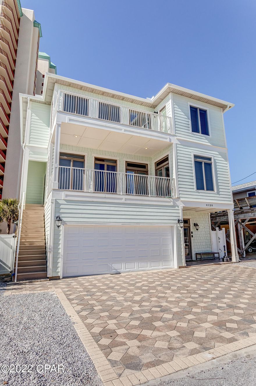 PROFESSIONAL PHOTOS COMING SOON: 5 Star rated VRBO turnkey rental, anticipating 160k-170k+ in rental income 2022, for a great ROI. VRBO#1222962 will show you booking dates, and plentiful reviews. Over $120k has been invested in various improvements over the last 4 years. The balcony views are second only to beach front, and you are only a 75ft walk to the beach. There are 7 sleeping areas and 4 full baths. In addition are two full kitchens and two laundry areas allowing this home to sleep 20 guests comfortably. Hurricane rated windows keep your insurance costs down. This home conveys fully furnished and has three HVAC units. Parking features 5 driveway spaces and a 2 car garage for 7 total parking spaces. No flood insurance required. Do not miss this opportunity, call your favorite Realtor