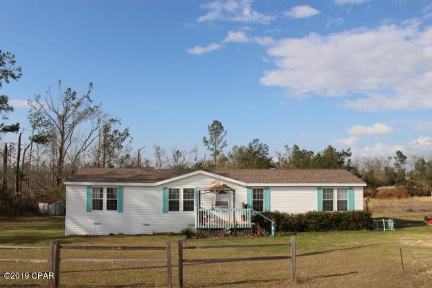 This updated Double Wide Mobile Home is in Move In Ready condition.  The hurricane Michael repairs have been completed. New roof in 2019. New wood laminate flooring in family room. The water heater and plumbing have been replaced with new parts. The septic tank has been pumped out and was inspected in April of 2017. This home is located on a paved road and is just minutes to I-10 & Hwy 231. Split bedroom floor plan. Open Kitchen, Dining, and Family room. Separate formal living room. Master Bedroom and bath are both large in size. Master bath has a garden tub & separate shower, double vanity sinks and large walk in closet. Back deck has plenty of room for entertaining and has a peaceful view. The carport & two sheds will convey with sale.  Property was surveyed when purchased.