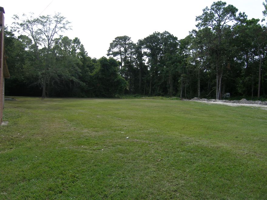 Beautiful Opportunity! Awesome Homestead or divide for separate homesites. This property has city water and sewer. A Split into two separate homesites is simple. Can be divided into more than three properties with Development order. 5 units per acres. Great for duplexes or townhouse. Beautiful lot. High and dry and level and cleared, ready for your home or build a few. House has no value. Old well on site.