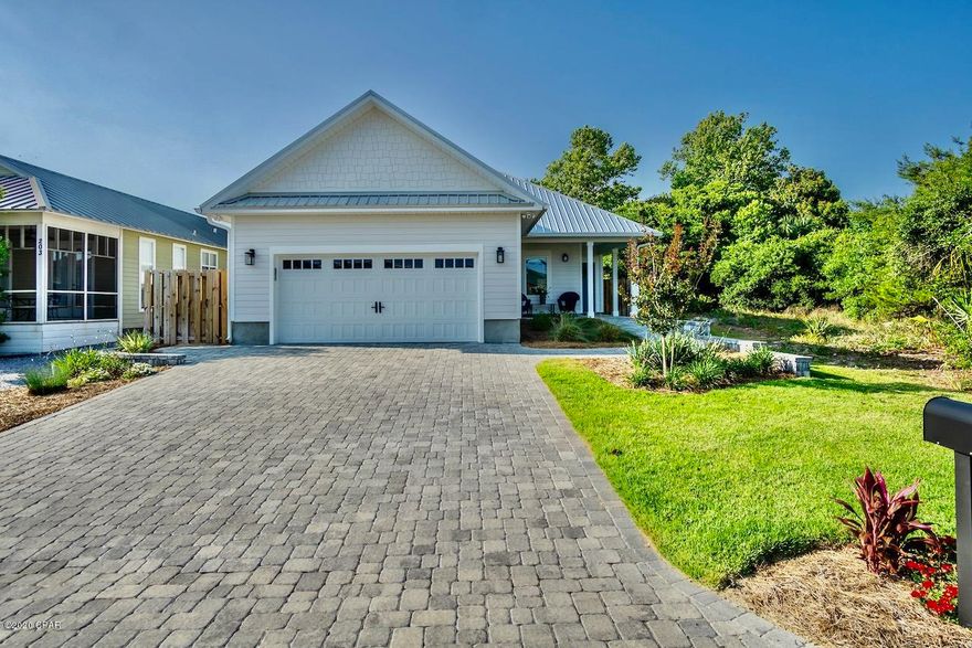 'CURRENTLY UNDER CONTRACT, SELLER ACCEPTING BACKUP OFFERS'Steps from the beach. Perfect home, Perfect location. Perfect for vacation rental or full time living.  This turnkey (everything is included) 4 bedroom (three kings & a queen) 3 bath home is ready for you to enjoy.  The master and two additional bedrooms are on the first floor for your convenience.  Amazing upgrades include impact windows and doors, top quality appliances, commercial scratch proof vinyl flooring, Quartz counters, irrigation system, back yard is pre-wired for a pool, spray foam insulation, metal roof and MORE!  Enjoy the fenced backyard on the covered porch after your day at the beach.  There is even a dog wash station in the double attached garage for your ''best'' friend.  Don't miss this one!  * all listing inform