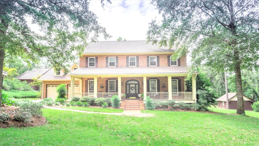 'CURRENTLY UNDER CONTRACT, SELLER ACCEPTING BACKUP OFFERS' Exquisite home on a prestigious 2+/- acre lot! This 3 bedroom/2.5 bath home exudes luxury with custom design and quality craftsmanship throughout. The kitchen is a chef's dream with island, stainless steel appliances, tiled countertops, pantry, breakfast bar and nook with panoramic views of the pool. Enjoy meals from the formal dining room with detailed trim work, gatherings from the spacious living area or catch up on work from the office all located on the main level. The massive Owner's suite features plenty of room for a sitting area, large walk-in closet, double sinks and a whirlpool tub with separate shower. Currently serving as a bedroom the spacious bonus area upstairs would make a great game room or craft area. Enjoy ultimate at-home entertainment with the 20x40 gunite pool equipped with salt-water filtration, heater, tanning ledges, lights, full screen enclosure, brick paver decking and a tranquil waterfall coming from the attached hot tub. Other outside features include luscious landscaping, attached 2 car garage, basketball court, workshop, a 40x42 detached shop with 3 roll up doors, one large enough to store a motorhome and a newly installed shingled roof on the house and barn. Property is located in the highly desirable Falling Waters area, just a short drive to Interstate 10 and Hwy 77.