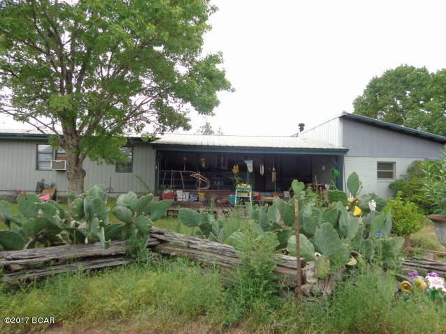 2 SW Mobile Homes, one with additions and one used as a rental plus a large metal airplane hanger and a separate metal building all on 10 acres. Property & MH's need lots of clean up.