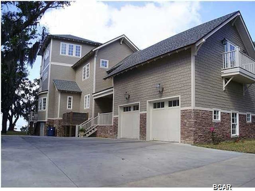 One of a kind! Custom built home in Kings Point. St. Andrews Bay on one side and Pretty Bayou on the other to keep your boat safe from the wind. You will love the fact that there is a view of the water from almost every room in the house. This 5600 sq. ft. home has so much to offer, from the hard wood floors, custom cabinets to the wood burning fire places in the great room and the master bedroom. With 7 bedrooms, 5 bathrooms, 2 bonus rooms and a basement there is no shortage of space. There is 127 ft. on the bay with a boat lift and dock on the bayou for all your boating needs. If you are looking for top quality construction and a waterfront home, this is a must see.