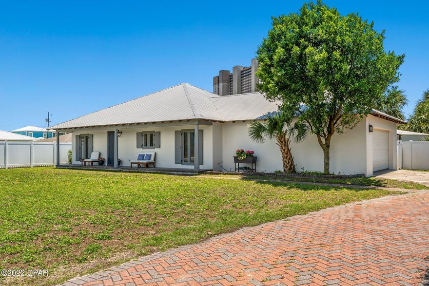This almost entirely renovated beach home sits on approximately .25 acres in an amazing location just a block from the Gulf of Mexico with a peek of the water. It is convenient to two public beach accesses and less than a mile west of Pier Park. The property is zoned Commercial High Intensity, which allows for short term rentals and more, and there is no HOA! Professional rental projections indicate $72,000+ annually. You will enjoy the Rosemary Beach style & design at a fraction of the cost while being a quick ten minute drive to 30A. The home has an open concept design with 3 beds, 2 baths, and a two-car garage. Recent improvements include new LVP flooring and trim throughout, interior & exterior paint throughout, a new bathroom vanity and additional tile in the primary bathroom, and upgraded lights. Stainless steel Kitchenaid appliances and washer and dryer are approximately 2.5 yrs old and HVAC is less than 6 yrs old. High-end original details like tongue and groove wooden ceilings, custom wooden doors, custom fireplace (has not been hooked up by current owner), exposed rafter tails along the roof, wooden functional shutters & poured concrete block construction give this home more character than other options at this price point.

Major beautification is underway to Front Beach Rd and Hwy 79, which are the main roads near the property. This project includes new sidewalks, bike lanes, wooded landscaped medians & underground utilities. It is scheduled to be completed by the end of 2023. This area boasts numerous restaurants & a grocery store within a short walking distance.

The large lot provides ample space for expansion or additional improvements. Currently, a portion of this area is wooded and the rest is used for additional parking and a secondary driveway next to the main brick paver driveway. The property is zoned Commercial High Intensity, which in addition to allowing short term rentals, provides greater flexibility for additional improvements and small building setbacks. Despite this, the property is surrounded by residences on all sides so the neighborhood has a relaxing residential feel. The front yard has a recently serviced and repaired sprinkler system connected to inexpensive City reuse irrigation water. The backyard has a vinyl privacy fence, covered porch, wooden deck & natural landscaping.

The possibilities for this beautiful home & property are endless & this neighborhood will become more and more sought after as the City's nearby beautification project progresses. All facts are deemed reliable, but should be verified by buyer.
