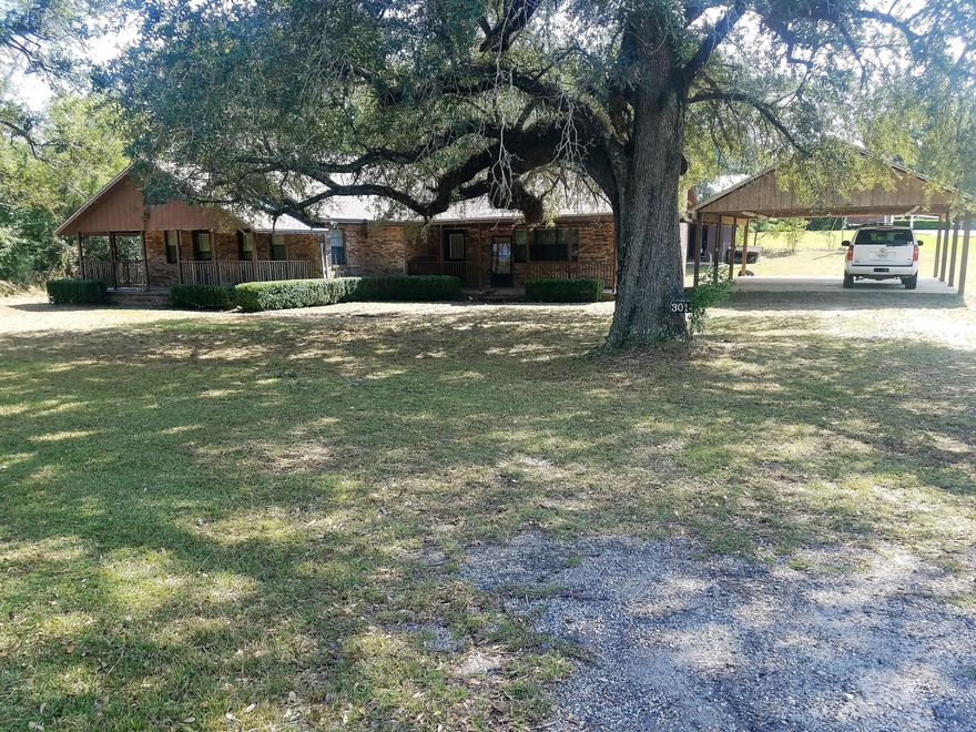 This is a huge four bedroom, three bath home sitting on the corner of Highway 90 and New Hope Rd on over 14 acres. There is a large open living area with a fireplace connected to a very spacious kitchen/dinning room. Attached and enclosed on the backside of the home is a 350 square foot bonus room that could be used for additional living area, office, or game room. All four bedrooms have bathrooms attached, two of the bedrooms share a bathroom in between with access doors from both rooms. Home does need some work, could use new floor covering, cabinets, and will need appliances. CALL TODAY THIS WILL NOT LAST LONG!