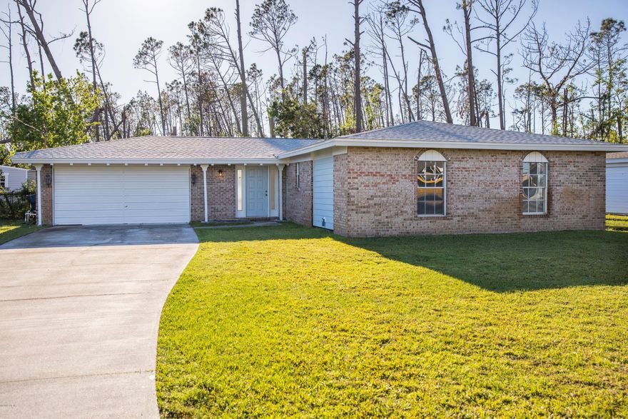 CURRENTLY UNDER CONTRACT, SELLER ACCEPTING BACKUP OFFERS Spacious 3-bedroom 2-bath brick home with 2 car garage located close to shopping and restaurants.  Home has some recent remodeling and includes fresh paint throughout.  Just installed Wainscoting throughout the living room and bath rooms.  Ceilings are finished with a beach flavor whitewashed ship-lap boards.  Incredible opportunity to make the kitchen your own as remodel is not complete.  Enjoy evenings under a covered patio. The fenced yard backs up to 4.582 acres of vacant property, so privacy is included.  If you have toys, the side yard is large enough to house a boat and RV without any compromises!  BONUS:   Nest thermostat, 2 Nest cameras on the front of the house, Nest controlled TV and sound bar. New roof, AC less than 4 years old.  $4000 flooring allowance and $500 door allowance and home warranty with reasonable offer.  Ernest deposit to South Oak Title, Grace Trucks.  Please submit pre-approval credentials with offer.