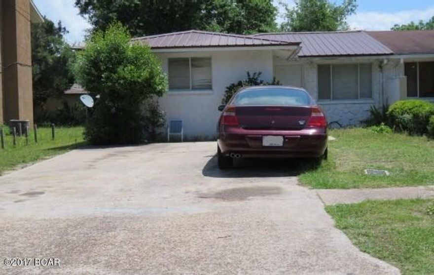 Attention Investors! Here is the perfect addition to your income producing portfolio. This 3 bedroom, 2 bath block and stucco 1/2 duplex is in good shape and is occupied by a long term tenant. Low maintenance tile floor throughout. Spacious living room and dining room, kitchen with all appliance and a split bedroom floor plan. A metal roof was installed in 2002. HVAC inside unit was replaced in 2014. Centrally located close to Panama City Mall, Hospitals and schools.