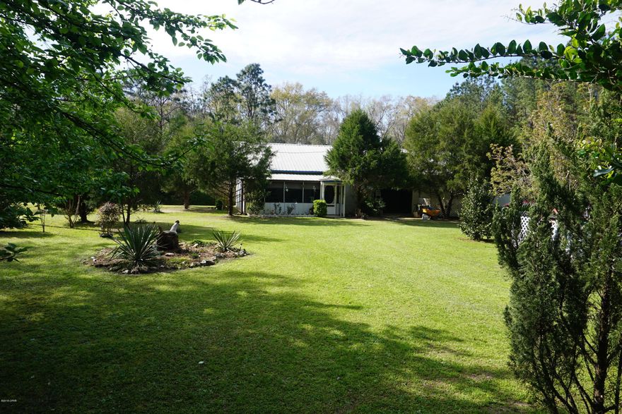 Cute house with 12 acres of land just minutes from town. This is a nice 2 bedroom 2 bath home with plenty of potential. Located on the back of the home is a 29' X 38' unfinished workshop that is waiting to be turned into heated and cooled sq footage. This property includes a 31' camper with sliders and a porch in front (the . It has about 6 acres of planted loblolly pine trees (damaged by Hurricane Michael), a fish pond, a storm shelter, a hot tub, an above ground pool, and an outside storage building (damaged by Hurricane).