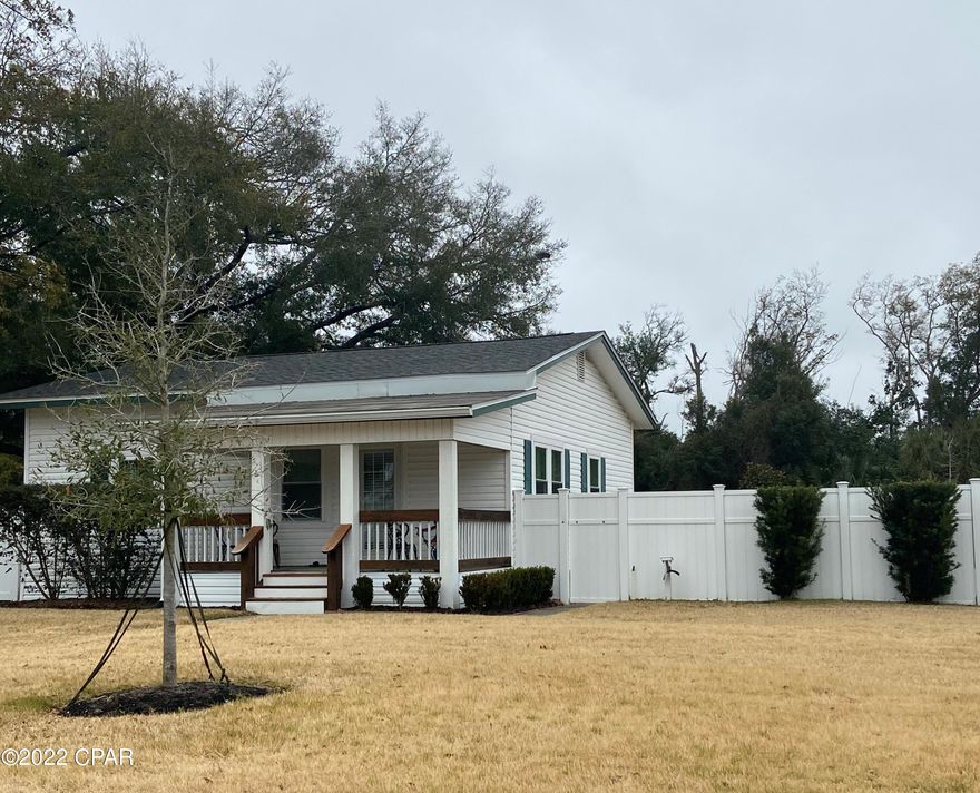 Charming Lynn Haven Florida Cottage close to the Panama Country Club! 2 bedroom, 1 bath home freshly painted and updated! Remodeled bathroom with tiled walk-in shower. New Roof on house 2022 with transferrable 30 yr. warranty, new roof on separate garage 2018. All new windows 2018. HVAC replaced 2019. Front Porch new 2019. New Hunter Node progammable Irrigation system (2018). Fresh sod 2018.  The kitchen has been redone with white cabinets and recent countertops, newer flooring and appliances. Large lot with fenced in back yard and large double 32x28 garage/ workshop with additional carport attached! Extra parking spaces. WILL GO FAST!