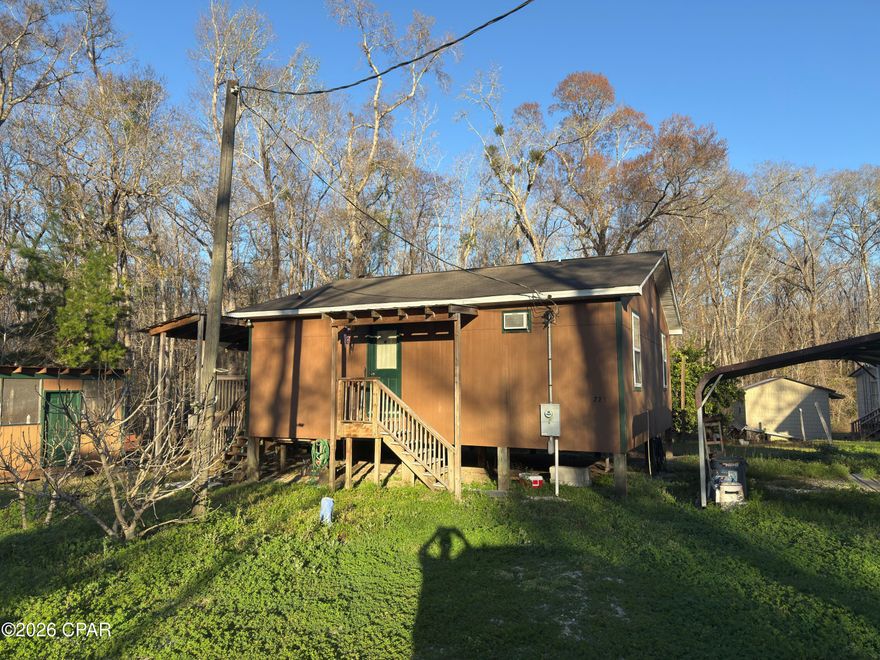 Turn Key cabin that is furnished less than 1500 feet from Bryant's Landing. Enjoy easy access to the Chipola River which is one of North Florida's truly remarkable ecosystems. Cabin is very spacious and is an open plan consisting of 2 bedrooms and 1 bath. Kitchen and dining area that open onto a screened porch suitable for enjoying the morning coffee or afternoon breezes. Plenty of closet space in the main living area as well as the bedrooms. Property also has covered parking as well as two additional storage rooms. Currently water and sewer are community owned and the annual fee is $600.00 for both. No HOA and only Gulf County restrictions. Less than 10 minutes to Wewahitchka, Only 20 minutes to Port St Joe, and about 25 minutes to Mexico Beach. Don't let this sportsman's paradise gem get away. Call today for an appointment