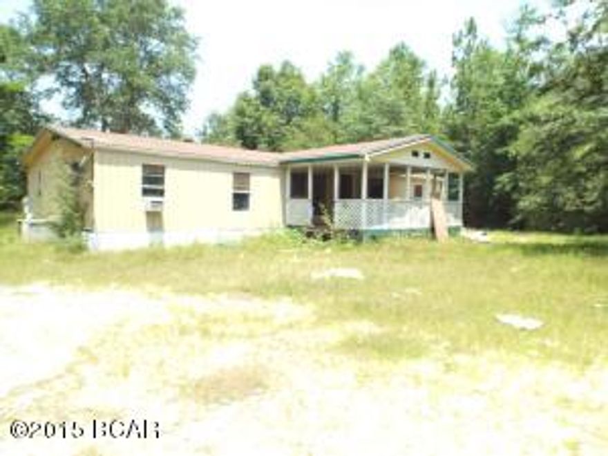 Three bedroom two bathroom manufactured home needing some TLC, on an acre lot offered as is.