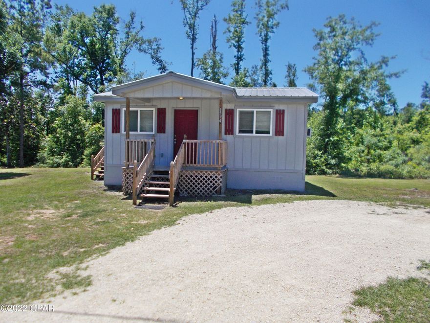 Tiny home lovers this is your dream, small cottage on .5 ac paved road corner lot, Tile kitchen, bathroom and laundry room and closet,, original hardwood floors lots of insulation in the interior and exterior walls, very easy to heat and cool, Fresh paint inside and outside. Submergible  well with a tankless hot water heater system, and a metal roof, Nice shade trees in the yard.