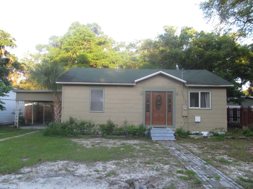 2 bedroom 1 bath home with a covered 2 car carport.  This home has an open floor plan, vaulted ceiling, breakfast bar and backyard brick fire pit.