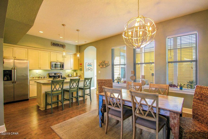 Enjoy all the beauty and relaxation offered by the upscale Island Reserve community! No more yard work and exterior upkeep of your home! This lovely,spacious, 2200 sq.ft.,two story home with 10 ft. ceilings features 20X18 living room with wet bar for entertaining that is open to dining/kitchen area. Kitchen has a huge walk-in pantry, island, granite counter tops, stainless appliances and custom cabinetry. First floor half bath provides convenience for guests. Large master suite features it's own balcony. The spa-like master bath has a deep, relaxing soaking tub, spacious walk-in shower, double vanity with granite counter top and custom cabinetry with tons of storage space as well as a huge walk-in closet. The twoadditional bedrooms each have private full baths. Two covered patio areas. Home has an attached two car garage. One acre pool in tropical setting with hot tub, in-door basketball court, game room, theater room, and gym will provide you and your guest with much to enjoy!! A one-year home warranty is provided. Please schedule a showing today. You will not be disappointed.