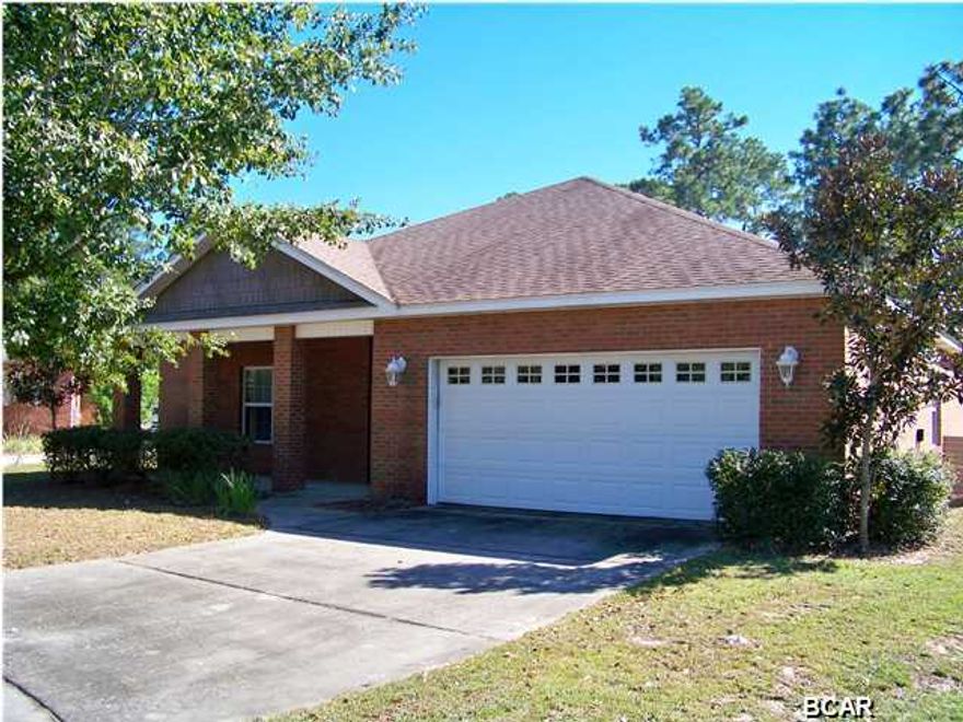 Handsomely appointed brick home in well-liked Hammocks subdivision. Enter the home through a charming covered porch that leads you into an open, tiled foyer with a handy coat closet and a half bath for guests. The Kitchen is large with an island, with lots of storage and abundant counter space covered with a solid surface Corian-type countertop. Quality wood cabinets and stainless appliances throughout the Kitchen. There is a separate desk area in the breakfast nook that is perfect for keeping notes and working on that grocery list. The formal dining room is spacious with plenty of room for family and friends. The great room features vaulted ceilings, a beautiful decorative fireplace and French doors that lead to a covered porch that would be perfect for relaxing after work, enjoying
