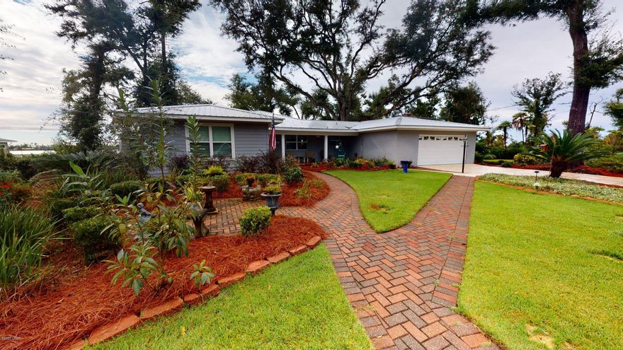 CURRENTLY UNDER CONTRACT, SELLER ACCEPTING BACKUP OFFERS Not your average lake house, this 1973 brick ranch had a complete renovation in 2014 including new septic system and upgraded electrical, beautiful new master suite, double vanity master bath, family room, new windows and screen porch. New irrigation system and roof in 2020. Three bedrooms, three baths, dining room, sunroom, fourth bedroom can be a separate den/office space. Brick exterior and HardiePlank. Front yard has brick paver walkways and extra parking pad along with a front porch, double driveway and 2 car garage. Large waterfront lot on Deer Point Lake with a newly built storage building with cooking porch, and the seawall and dock were replaced in 2019. High elevation does not require flood insurance. Come see this lake fro