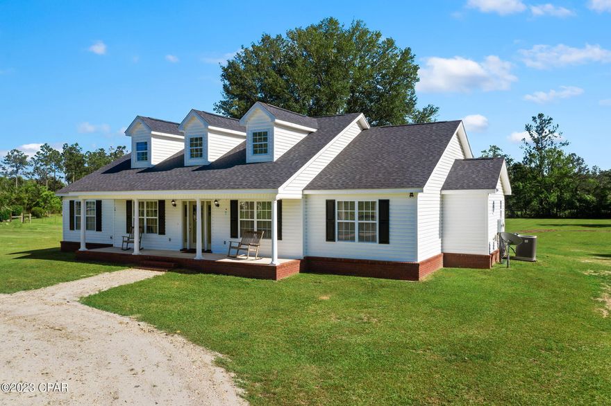 Located just minutes from town this 4 bedroom, 3 bath custom home is perfectly situated on 3.3 +/- acres! Walk inside and you are immediately greeted with a spacious living room boasting cathedral ceilings, formal dining room, large kitchen with an abundance of cabinetry, stainless steel appliances and island. Escape to the oversized master suite featuring his/her walk-in closets, soaking tub, separate shower and double vanities. Your guest will feel a sense of privacy with the spare bedroom and bath located on the opposite side of the home.  Outside you will find covered front and back porches, circular driveway and detached workshop. Property is located a short drive to Falling Water State Park, Interstate 10 and Hwy 77.