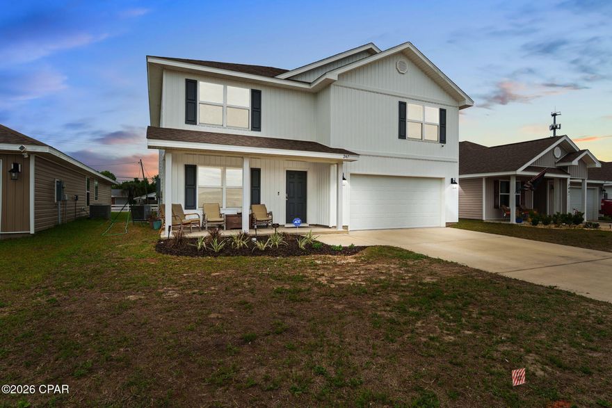 Welcome to this beautiful Craftsman-style home in Bridge Harbor, conveniently located near Tyndall Air Force Base. This versatile floorplan offers either 5 bedrooms and 2.5 baths, or 4 bedrooms with a dedicated office. The home features a spacious living area that flows seamlessly into a well-appointed dining and kitchen space. Interior highlights include durable vinyl flooring in main areas, carpet in the stairs and bedrooms, laminate countertops, and classic 8-foot ceilings throughout. This home comes standard with a Smart Home Technology package, including KwikSet keyless entry, a SkyBell doorbell, and automated front porch lighting.