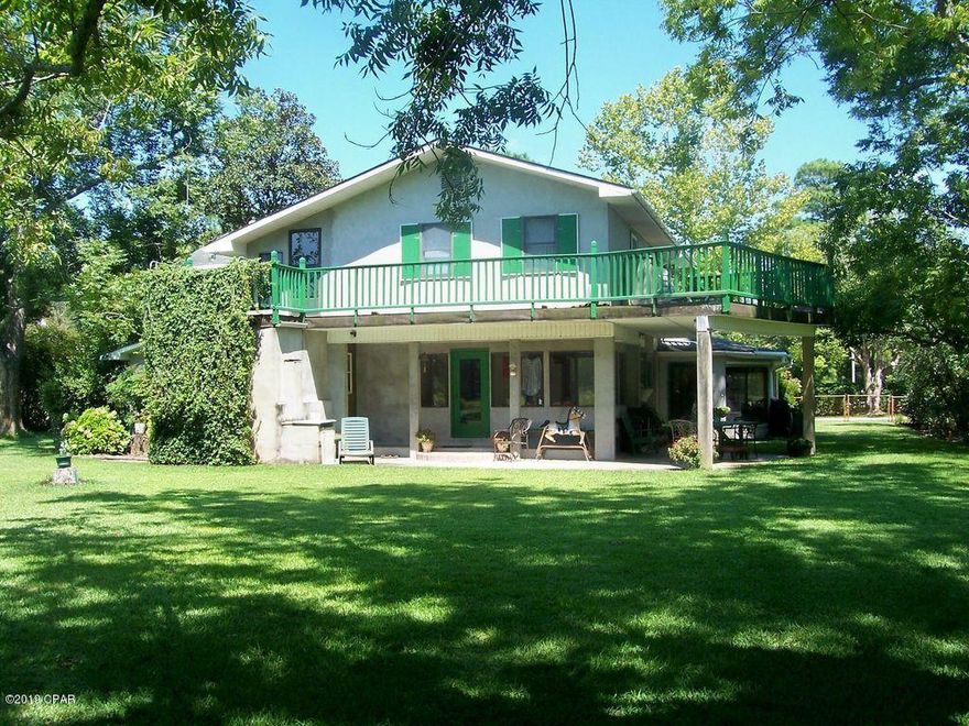 Attention Investors: Huge property on a corner lot with a variety of trees and shrubs. It has two stories with wrap around upstairs deck, 9 ft ceiling in 23x24 ft living room, 24 by 40 ft two-story garage. It also features a concrete drive though driveway. The house is completely gutted and vacant. This property has an elementary school across the street and in between two large shopping areas of the Panama City area.