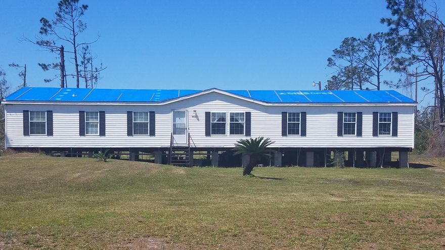 Don't miss the chance to own 1.5 acres in the Bayou George/Youngstown area. Double-wide trailer has an extreme amount of living space  with 4 bedrooms/2 bathrooms, a large living, dining and den area, which is great for entertaining. Wood burning fireplace, spacious bedrooms and a huge back deck will give everyone space to move around.

The front and back yard are manicured, and there are neighbors and stores very near.  

Damage repair from Hurricane is STILL needed and seller has quotes for all trades.