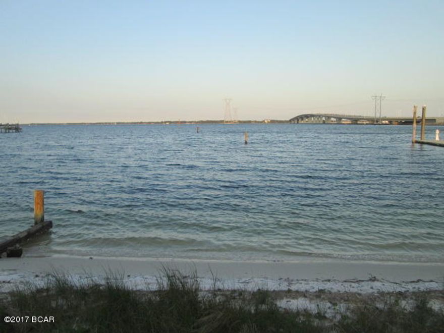 Bay-front estate-sized lot, 1.05 acre.  Woodlawn neighborhood.  120' of bay front with beautiful sandy beach.  Good water depth for boats.  Eastern exposure with shaded afternoons and tremendous sun and moon rises.  Over 365' of depth.  Deep-water marina next door with large slips (up to 55' boats) available for rent.  Part of a parent tract.  This listing is for 120' of bay frontage.  Precise frontage, dimensions and area is flexible and to be determined by survey.