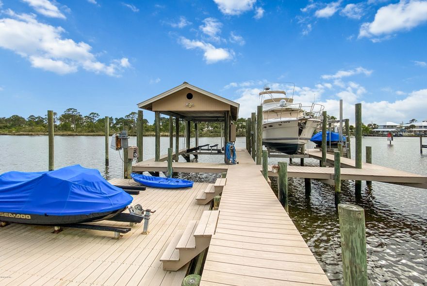 A BOATERS DREAM!!! Opportunities to live on GRAND LAGOON are a rare find. 100 feet of water frontage and extra dockage space on the lagoon. Quick access to gorgeous Shell Island and the Gulf of Mexico. LARGER PIER & DOCK Bringing EXTRA VALUE to the property. The pier and dock are larger than normally approved for the frontage. Seller obtained a variance from the Neighbor on the west side. Seller also has approval from the DEP with a Land lease survey.  This dock is legal and approved by the DEP with a land lease in place. The lease is $400 a year.  Composite decking boardwalk leading from the pool area out to the enormous dockage and boat house area consisting of two independent boat lifts, one rated at 16,000 pounds and the other rated at 10,000 pounds. One JetSki lift, swing type, rated for the largest JetSki. Jetski can be set on Dock or on lift at side of dock. JetSki/Dinghy -Dock which raises and lowers in the water.  This is set up to accommodate one JetSki and one dinghy. 
This Prestigious Senior Executive waterfront home is a must see. Gated entrance with immaculate brick pavers leading you directly up through the circular driveway to the grand entrance and front courtyard that welcomes you to your front door. Upon entering the home, the grand foyer makes a statement of elegance and Florida charm with high ceilings throughout. 
Three large bedrooms, Two full baths, and a powder room, two living rooms, a Florida room for morning coffee or afternoon tea, and an additional bonus office/game room with private entrance. Custom faux, textured ceilings and walls. Well maintained home has barrel tile roofing with luscious landscaping, custom gunite pool & water feature, with a stand alone hot tub.
The hot water heater was replaced in 2017 and brand new pool pump. Make an appointment to see this home, too many great features to list them all.