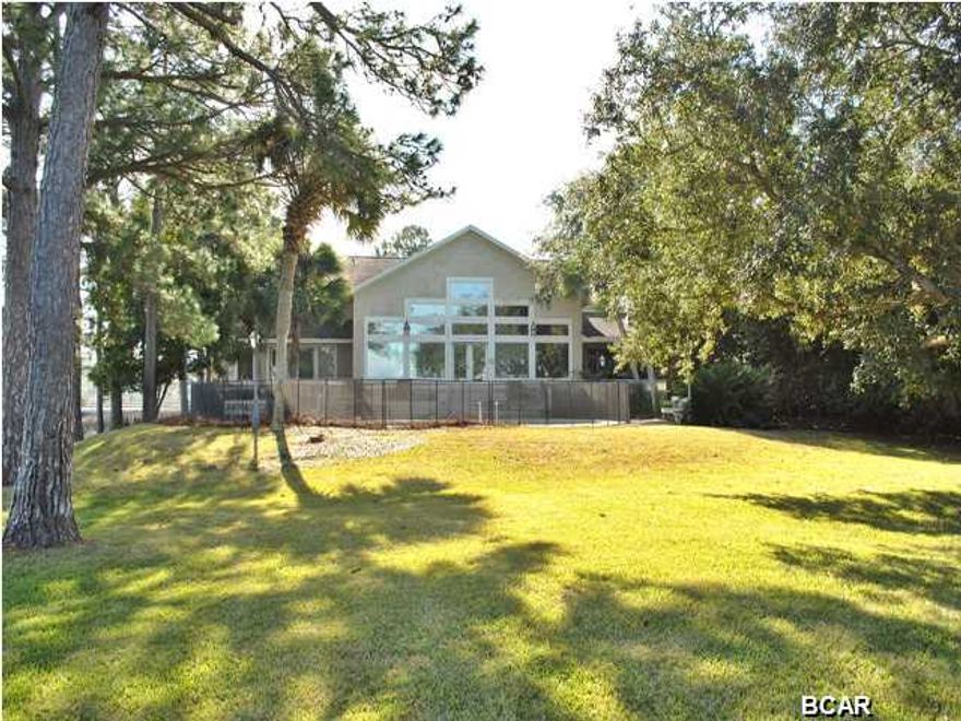 If you are looking for spectacular views of the Bay or watching the birds of the Kings Point lake, this is the perfect spot for you. This single owner custom built 4 bedroom homes offers a very open floor plan with vaulted ceilings, double sided fireplace, downstairs master bedroom with an office plus exercise room. The views of North Bay are visible from all rooms in the house and the side yard fronts the opening to Kings Point lake, where kayaking and canoeing are favorite past times of the neighbors. The kids will enjoy playing in the swimming pool and then running along the natural beach and waters edge of the bay. Kings Point Harbor is centrally located in Panama City and close to medical, schools, shopping and restaurants.
