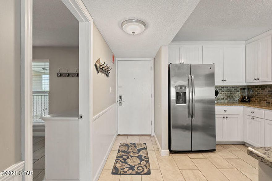 CURRENTLY UNDER CONTRACT, SELLER ACCEPTING BACKUP OFFERS.  Coastal Chic! Gulf Front Updated 2 bedroom/2 bath unit in the popular Dunes of Panama Phase IV complex. This unit with expansive Gulf front views is tiled throughout.  The kitchen features stainless steel appliances and granite counter tops.  Units like this are not lasting long in this crazy market. This is a well maintained unit that won't last long!