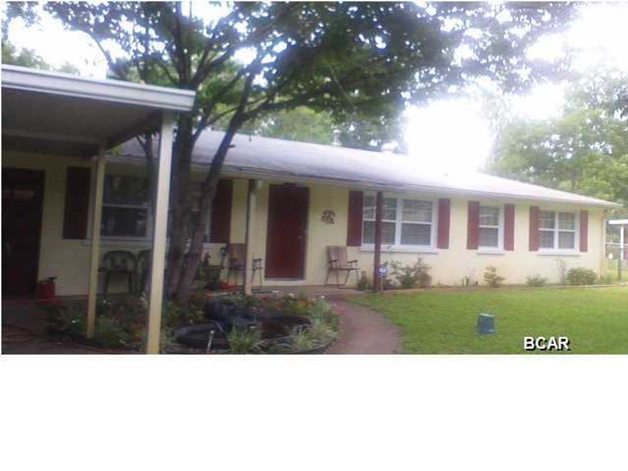 5 BR 2 BA Home with carport, security system, hardwood & tile flooring. This home features a large yard and yard building with full bath.