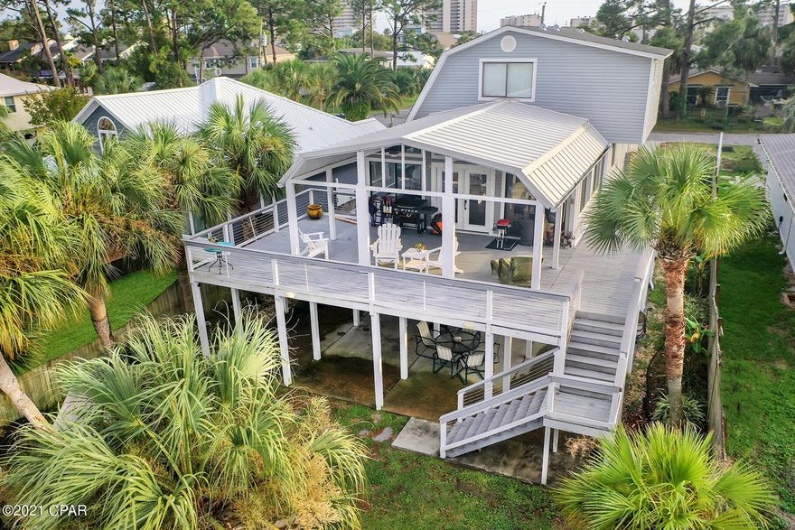'CURRENTLY UNDER CONTRACT, SELLER ACCEPTING BACKUP OFFERS' - 

Salty Living is Best!

The entire Grand Lagoon area is a local treasure enjoyed by a community of friendly neighbors and backyard docks that access the beautiful Grand Lagoon.  Relax as you enjoy passing boats or perhaps some dolphins swimming in the lagoon from your Covered Patio or the huge Covered Deck.  To be sure, the ambiance is breathtaking in this spacious Home Office; the comfy Family Room and even the Kitchen and Dining Room feel beachy!  This fully furnished 3-bedroom /4-bathroom 2,060 sq. ft., Craftsman style Home sports 54 Waterfront Feet on the Lagoon with a 73' dock.  The Boat Lift is fully functional and even has a Fish Cleaning Station attached. Imagine pulling up fresh blue crabs from your backyard!  A Seawall creates a crisp separation from the lush yard to the Lagoon.  The Master Bedroom Suite offers a Private Balcony and a nice Master Bathroom with a Whirlpool Hot Tub to spoil yourself.  On the ground level a convenient Activity Room and Full Bathroom lend additional options to the already spacious Home Office space that overlooks the Grand Lagoon. Vinyl Siding and a Metal Roof are quality; designed to provide years of shelter The double-car garage will be convenient to store the golf cart that comes with this property.  Call Listing Realtor for details.