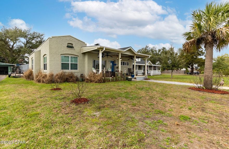 CURRENTLY UNDER CONTRACT, SELLER WILL CONSIDER BACKUP OFFERS..Welcome to 213 N. Cove Blvd. As soon as you walk through the doors you'll notice the uniqueness of this Cove home, with arched entryway, multiple built-ins, and custom touches throughout that make this 4-bedroom 2 bath a must-see property. The flow from the entryway to the living room with cozy wood burning fireplace into the spacious open kitchen with tons of cabinets is perfect for entertaining. Three of the bedrooms and a bath are located on one side of the home with the custom master suite on the opposite side, tucked away behind handcrafted French doors, making for a highly sought after split floor plan. Off the kitchen is an enormous utility and laundry room which leads to a backyard that is filled with numerous amenities, basketball area, tiki bar with swings, two large storage sheds with AC units and garage or workshop building with two roll up doors and a small bathroom. Also, a covered parking area is adjacent to the garage and has access to the alley behind. Located in the historic Cove where you can walk, bike or golf cart to our amazing downtown restaurants and local events or to St. Andrews Bay to enjoy the nightly breathtaking sunsets, this home has so much to offer you'll want to schedule your private showing today!

Black refrigerator in the kitchen does not convey.  The white refrigerator in the laundry room is the one which stays with the home.