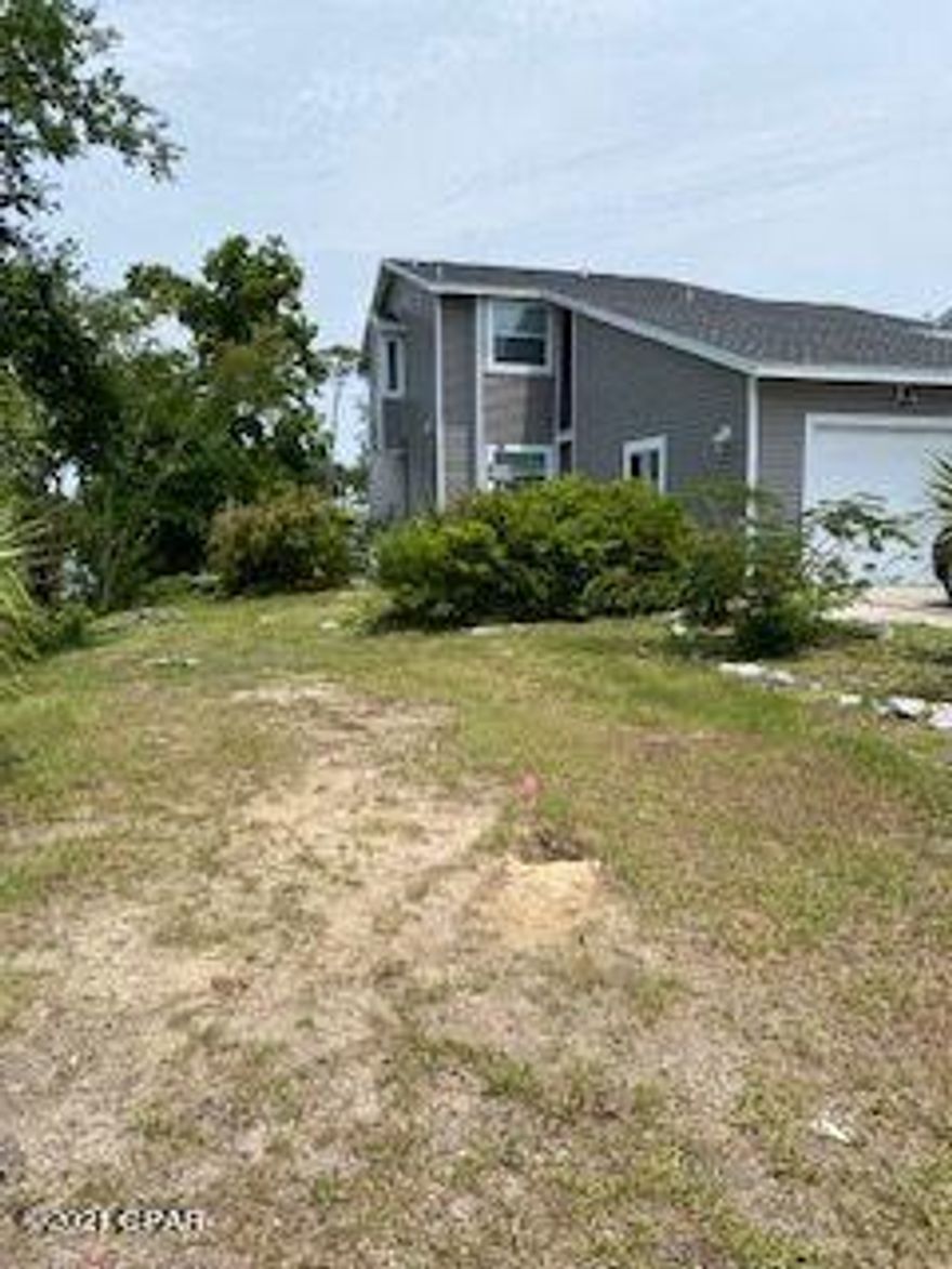 WATERFRONT views from the upstairs Master Bedroon, Master Bath, upstairs Hall and Living Room.  This home is located on Watson Bayou which leads to the Bay and out to the Gulf of Mexico.  It has been freshly painted inside, a new roof and new windows installed in 2019, all bathrooms have been completely redone as well as the kitchen with all new appliances.  The large side yard enables owners with a place to park a boat or RV with a sewer line available.  There is a large wrap around deck/porch to enjoy your waterfront views while having your morning coffee or after work relaxation time.  This home is MOVE-IN ready and is currently the ONLY home located on navigable water at this price.  Don't wait - check it out today.