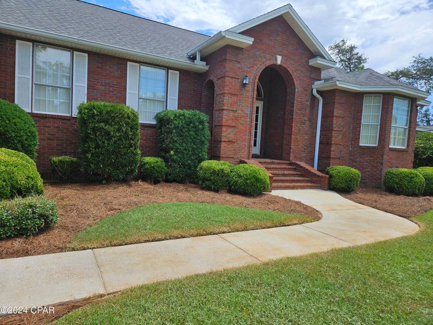 'CURRENTLY UNDER CONTRACT, SELLER WILL CONSIDER BACKUP OFFERS' This full brick, 3 bedroom, 3 full bathroom home can handle a large family as it has more than 2,100 square feet. The tall ceilings make it feel bigger. The master bedroom and the third bedroom has a full bathroom in addition to a full bathroom in the hallway. It has a separate dining room, eat-in kitchen and a breakfast bar. The covered back patio can be accessed from the eat-in kitchen area as well as the master bedroom. It is all on one level with the only steps at the front door and the 2-car garage that has an electric chair lift. Much of the big home has crown molding and flooring includes hardwoods, carpet and tile. The kitchen has plenty of room and has a double oven, electric cook top, lots of counter space and a breakfast bar. The double sink area is open to the living room and eat-in area. After Hurricane Michael the roof was replaced as well as all the insulation in the attic. The yard has a sprinkler system and the landscape company tends to the lush green grass. The home is not far from plenty of shopping, restaurants, bay access, and the World's Most Beautiful Beaches. Note the captions with each of the 50 photos.