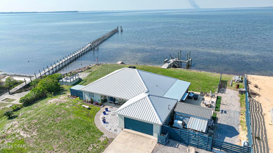 There is Waterfront and then there is WATERFRONT.  Welcome to 4018 PRINCESS LANE. end of the road privacy with over a half-acre lot with over 260' of Western wrap around never-ending beautiful sunsets and marine wildlife. within 30' of the shorelines everything from Dolphins, Manatees, Eagles, Ospreys and many other bird species. Being the end corner lot allows for one side of no adjoining neighbors. This beautiful but modest home sits in the middle of over half acre lot leaving a lot of space all around the property. There is over 1,700 sq ft of waterfront views from every room. The home is a 2-bedroom 2 bath home with an additional home office with a waterfront view, too. This 10X10 room could be converted into a third bedroom if necessary. There is a beautiful Sunroom with new hurricane windows to sit and enjoy the bay. The improvements recently completed to the home are: New hurricane proof windows at a cost of $50,000.00, A 25-Kilowatt generator that will run the entire home for 2 to 3 weeks without power, An entire new rip wall seawall for additional storm protection $35,000.00, All new spray foamed insulation through entire home $7,500.00, An outdoor 30' x 40'  partially covered entertainment concreted area with room to lounge and enjoy the outdoors and soaking up the sun! Theres an outdoor kitchen area- $20,000.00, the new dock was constructed in 2020, $15,000.00. The dock will handle up to a 25' to a 28'' boat easily in the summer as the winter tides get shallow. Dock could be extended if needed. There is DIRECT GULF ACCESS from the back yard. Privacy fence blocking the neighboring yard. The home is ready to move in!  Waterproof laminate flooring throughout the entire home. Widened driveway allowing for 4 car parking in the driveway plus adjoining gravel drive for 2+ additional cars. New 10'x16' storage building and an additional drive all the way into the back yard with a private area down to the water which has full hookup for an RV which gives you and your guests privacy when they come to stay longer than you really choose for them to,  Short term rentals are available in this area which would make for a great rental investment property and still allow all the private  use you would care to enjoy.  A small separate 12' x12' upper deck was built to enjoy the view over the small bayou area beside the home which has plenty of storage underneath for beach chairs, outdoor games, etc... Please pardon the YARD as we are currently working on beautifying it. Allow a 24-hour notice for appointments as the home is occupied however we may be able to accommodate on short notice. The owners are Licensed Realtors.