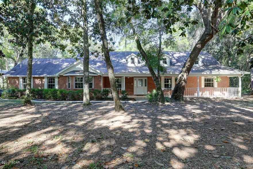 All brick 3BR/3BA on a slough of Deerpoint Lake. This 3 acre homesite is an oasis for nature lovers and family fun with enclosed in-ground pool and backyard access to some of the areas best fishing by jonboat or kayak.  Huge front porch, 3 car garage and 20x48 Pole Barn w/ 50 amp hook-up for RV. Interior features an open, airy kitchen with custom cabinets and island, large dining area, living room with wetbar, wood-burning fireplace and built-ins, opening up to the heated and cooled Florida Room that stretches end to end along the back side of the house. Master Bedroom is huge, with hardwood floors, his & her walk-in closets and French doors leading to Florida Room and pool.  The Master Bath has double vanities, jacuzzi tub and walk-in shower.  Each bedroom has a full bath,  (Continued...) one of which is handicap accessible.  The backyard is fully fenced, so those with dogs don't need to worry about unexpected lake swims.  The attic has been floored for additional storage. Hurricane shutters and a transferrable termite bond are included. While the house is connected to county water, there is a deep well with "sweet water" if ever needed.  Irrigation system is hooked up to the well.  A must see for the price!  Please schedule a visit to see if this is the home for you.  All measurements and dimensions approx. and should be verified by Buyer if important.