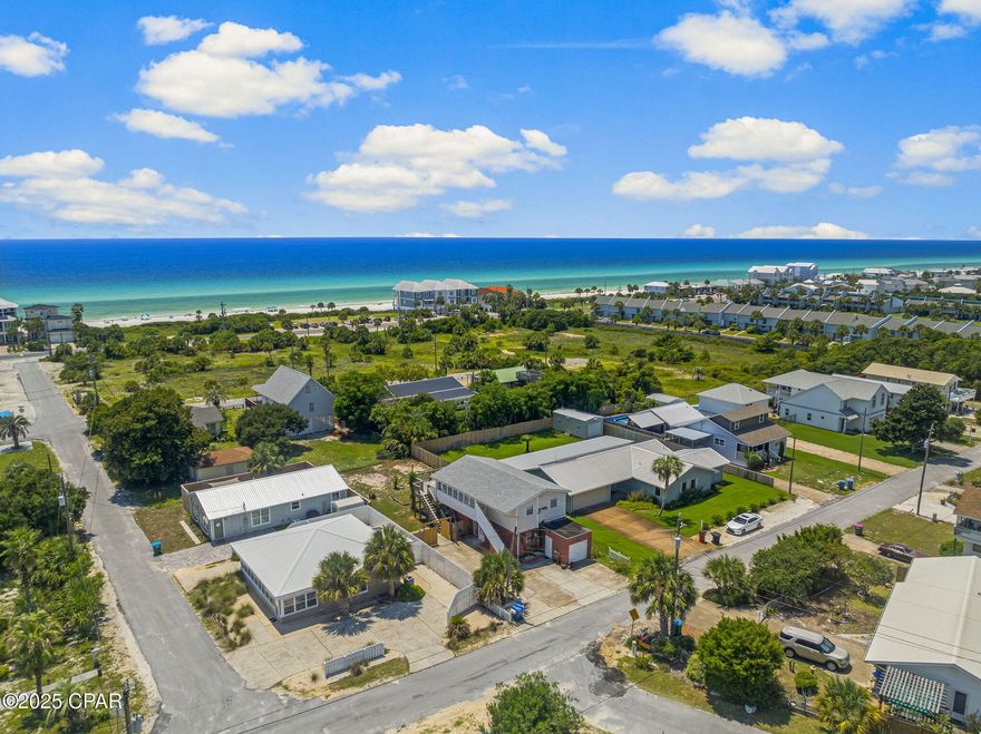 Discover a prime investment opportunity in Panama City Beach's coveted west end, just 0.2-miles from doorstep to Public Beach Access #92 and the Gulf's white sand beaches. Only 4 miles from upscale dining and shopping at 30Avenue or Rosemary Beach, and 7 miles from Pier Park and Frank Brown Park—home to events like Gulf Coast Jam—this location is unmatched for coastal living.

This versatile duplex offers flexibility for buyers. The upstairs unit, with a kitchen, living area, dining space, one bedroom, and a full bathroom, can be reconfigured into a two-bedroom, one-bath layout. Enjoy a spacious 26' x 16' balcony with partial Gulf views and a sunroom, perfect for relaxing or soaking in sunsets. The downstairs unit has a ground level entry into the open living, dining and kitchen space. There are 2 bedrooms and a full bathroom downstairs. There is a single garage that is perfect for a golf cart and beach supplies. 

For savvy investors, this property is a rare find with multiple revenue streams. Continue its proven success with long-term or short-term rentals.  There is ample space for a pool, carriage house, an addition and other enhancements. Unlike a single-family home, this duplex offers dual-income potential or the option to live in one unit while renting the other. 

This classic coastal gem blends timeless charm with significant investment potential in one of Florida's premier beach destinations.