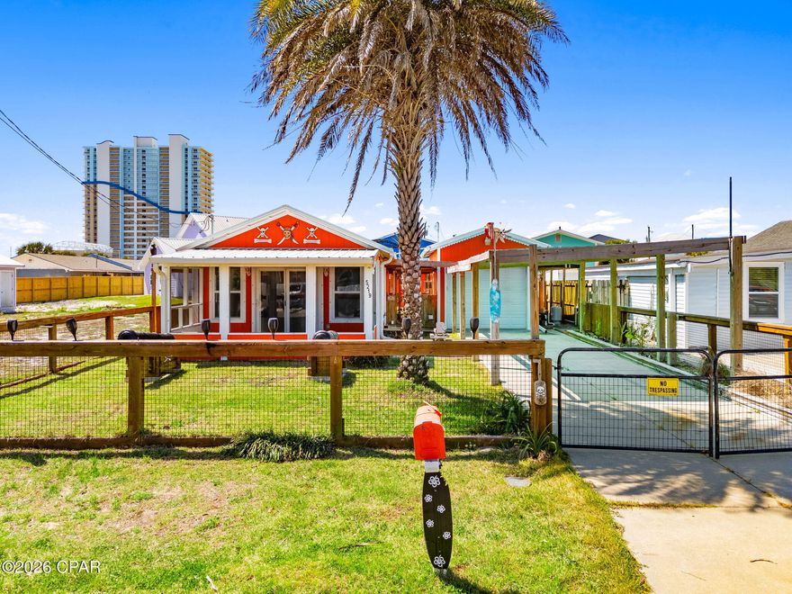 Welcome to Pirate's Paradise, a truly unique coastal cottage complete with two authentic, themed cannons that set the tone for this fun and memorable beach escape. The detached garage/studio and oversized storage shed adds extra value to this one-of-a-kind property. Perfectly positioned in one of the best locations on East Panama City Beach, you're just an 8-minute walk to Beach Access 4 and Schooners, and only a 3-minute drive to St. Andrews State Park, ideal for beach days, boating, and exploring the Gulf Coast's most beloved natural areas.

Built in 2016, this charming home features durable Hardie board siding, a metal roof, a welcoming screened front porch, and a fully fenced yard for privacy and outdoor enjoyment. Major mechanical peace of mind comes with a new AC installed in 2024. 

Inside, the home offers a bright, efficient layout with thoughtful upgrades throughout including:
non-slip tile flooring - durable, and perfect for sandy feet, open-concept living and kitchen with granite countertops and island bar, inside laundry hookup, spacious primary suite with walk-in closet, 2'' blinds throughout, and a huge walk-in tile shower with a new vanity in the bathroom. Move-in ready or rental-ready with low-maintenance finishes.

The detached garage is divided into a studio on the back and golf cart garage in the front. The garage studio a rare opportunity for additional rental income potential with insulation, walls, wall AC unit, and laundry hookup already installed. Finish out as a studio apartment with kitchenette and bathroom for a private guest suite. If you're looking for garage space, it can easily be converted back to an oversized one-car garage as well.

A large backyard storage shed adds even more flexibility - ideal for a game room, workshop, hobby space, or extra storage.

Whether you're seeking a personal beach getaway, a short- or long-term rental, or a property with room to grow, Pirate's Paradise delivers unmatched character and potential in one of Panama City Beach's most desirable areas.