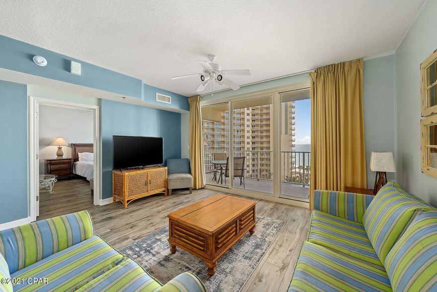 LOWER FLOOR UNIT. Take in peaceful, elevated water views in this stunning Shores of Panama Condo. Offering a lovely living room and master bedroom with direct pool and Gulf views and a private bunk-room. Additionally, two full baths make for wonderful ease of living. Enjoy welcoming, beautifully furnished spaces with new wood look flooring, upgraded lighting, and vibrant color scheme. Relax by the pool or in the inviting living room or sip a cool drink out on the spacious oversized balcony and gaze at the pool and Gulf beyond. Amazing open floor plan with a rare layout. Turnkey and ready to rent. Fantastic investment opportunity! 

Shores of Panama, is a 23 story Tuscany style condominium of gulf front luxury accommodations offering unparalleled amenities including almost 500' of Gulf frontage, 13,966 sq. ft. million dollar Gulfside, zero entry lagoon-style gulf side pool, Gulf side hot tub, Large heated indoor pool & hot tub, Covered on-site parking deck, Health center with fitness equipment, Two tiki bars serving lunch and dinner, Beach activities and rental services, Free high-speed internet access,  and more, surrounded by beautiful exterior details. The Shores of Panama is an excellent location on the beach next to Pineapple Willy's and is within walking distance of other restaurants and entertainment. Like thousands of visitors each year, your family will LOVE Shores of Panama.