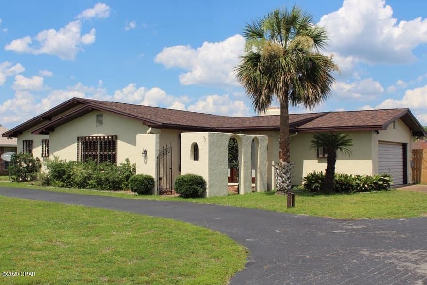 'CURRENTLY UNDER CONTRACT, SELLER ACCEPTING BACKUP OFFERS.  This home sits on a HALF ACRE LOT in central Panama City, convenient to the restaurants and shops of 23rd street. Upon entering the home you will instantly notice the large living area and beautiful new LVP flooring. Other features include a separate den for additional entertaining, a 2 car garage, ample parking, and gorgeous Spanish detailing (including archways, a brick fireplace, and a brick outdoor patio). All new flooring, windows, paint, roof, smooth ceilings, hot water heater, sliding glass doors, and fencing. You will not find outdoor entertaining space like this anywhere else, and it is the perfect size to add a pool should you wish to. Turn key, completely FURNISHED, and ready to go with no concerns!