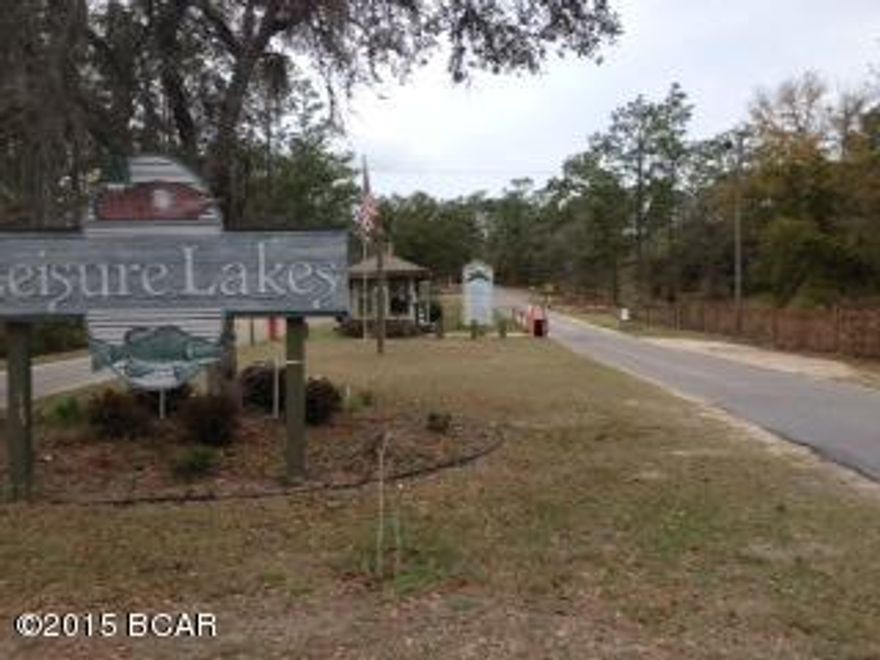 Looking for 5 acres? Welcome to the gated community of Lesisure Lakes, about 30 minutes north of Panama City. The subdivision offers activities for the entire family including 2 lakes, 2 boat ramps, fishing, boating, kayaking, swimming pool, pavillion with restrooms and rental kitchen, basketball and tennis courts, a playground for toddlers, and a picnic area. Each lot owner has a code to get through the security gate, and live guards are on duty weekdays. This 5.1 acre lot is not far from the entrance to the subdivision. It is flat with plenty of shade trees and ready for your home, or would make a good investment.
