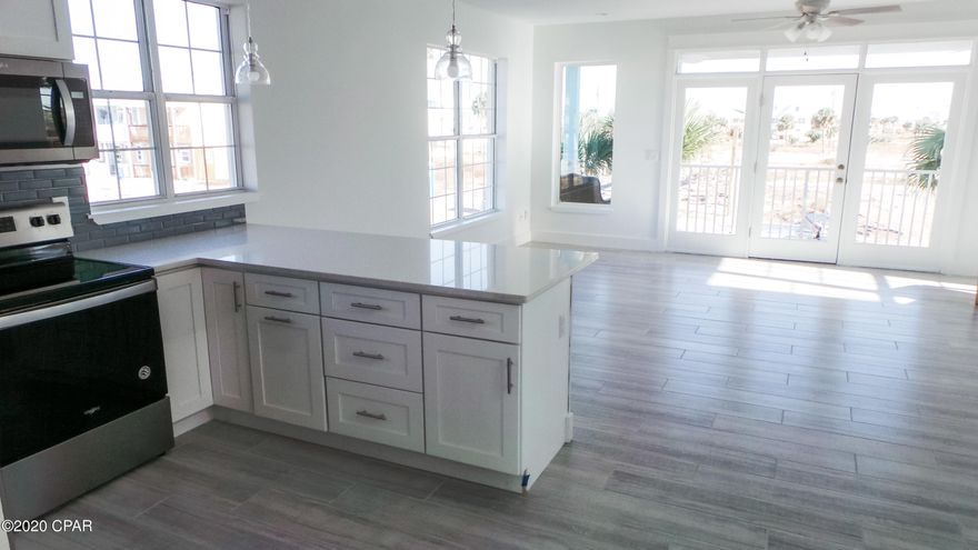 400' is the distance you'd have to walk from your front door to the beautiful Gulf of Mexico.  Public Beach access is located right to the end of the street.  Live at the water's edge without the fear that comes with it.  This house, located in Oceanside Village, is one of the few that made it through Hurricane Michael.  That's because it was built with a steel frame and poured in concrete.  Enjoy the Florida lifestyle while maintaining your peace of mind.  Recently remodeled, this home offers 3 bedrooms, 3 bathrooms, and water views from the porches.  Entertaining will be a breeze with the full mother-in-law suite on the first floor.