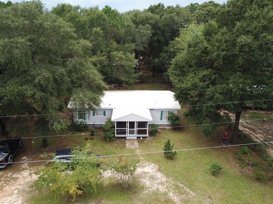 Located near Juniper Lake this 3 bedroom 2 bath home is surrounded by large shade trees only a half mile from public boat launch. Large yard and with plenty of storage for boats, jet ski's or travel trailer including storage shed. New metal roof, floors, and HVAC all installed within the past 2.5 years. Spacious living room and formal dining area. Kitchen features plenty of cabinets and counter space, large pantry, with adjoining laundry room with washer and dryer. Master bedroom has walk in closet. Master bath includes large tub with separate shower. Large new screened in covered front porch with new decking great for entertaining.