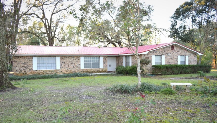 Looking for your own personal oasis? This 3 bed 2.5 bath home is nestled on 10 secluded acres and boast a large living room with wood burning fireplace, sliding glass doors offering stunning views of the backyard, eat-in kitchen with walk-in pantry and new appliances, den area that could serve as a fourth bedroom or gameroom,  master suite with double vanity and an abundance of storage throughout. Outside you have it all, 50x60 barn with electricity, workshop, oversized rear deck, 2 car attached carport, pond, massive oaks, luscious landscaping, seedless grape vines, multiple fruit trees including lemon, mulberry, orange and grapefruit. Property is located less than a mile from Hwy 77 and Interstate 10.