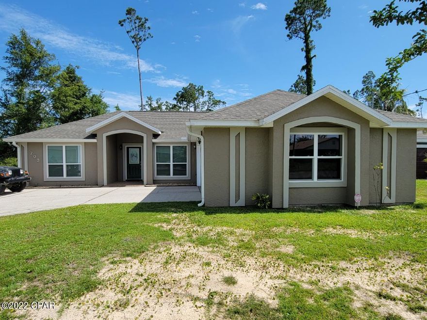 DON'T MISS THIS OPPORTUNITY! Beautiful 3 bedroom, 2 bath, split floor plan, one owner home, centrally located two blocks north of  23rd St. Large 12x16 master, walk-in closet, and master bath with separate tub and shower. Enjoy the evening on the screened-in porch or relax on the open patio outside the master bedroom. Home has an oversized garage, and outdoor shower fixture for days after the beach or gardening. This home has been updated in 2021 with new Pella windows, engineered hardwood plank flooring, exterior and interior paint, new hurricane rated garage door, new HVAC system in 2018, and much more. Most major appliances updated since 2018. Home is under a current termite bond, and has an installed security system. This meticulously maintained home will not last at this price.