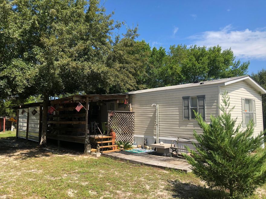 Like new and well-maintained mobile home on a huge lot. This home comes with 3 bedrooms, 2 of which will be furnished and is move in ready with central A/C. Includes a metal shed, carport, porch and an open workshop on the property. Lots of room for your kids to play or dogs to run in the fenced in yard. No HOA fees. No flood insurance required.  Close to the beaches, recreation, shopping, restaurants and 30A.