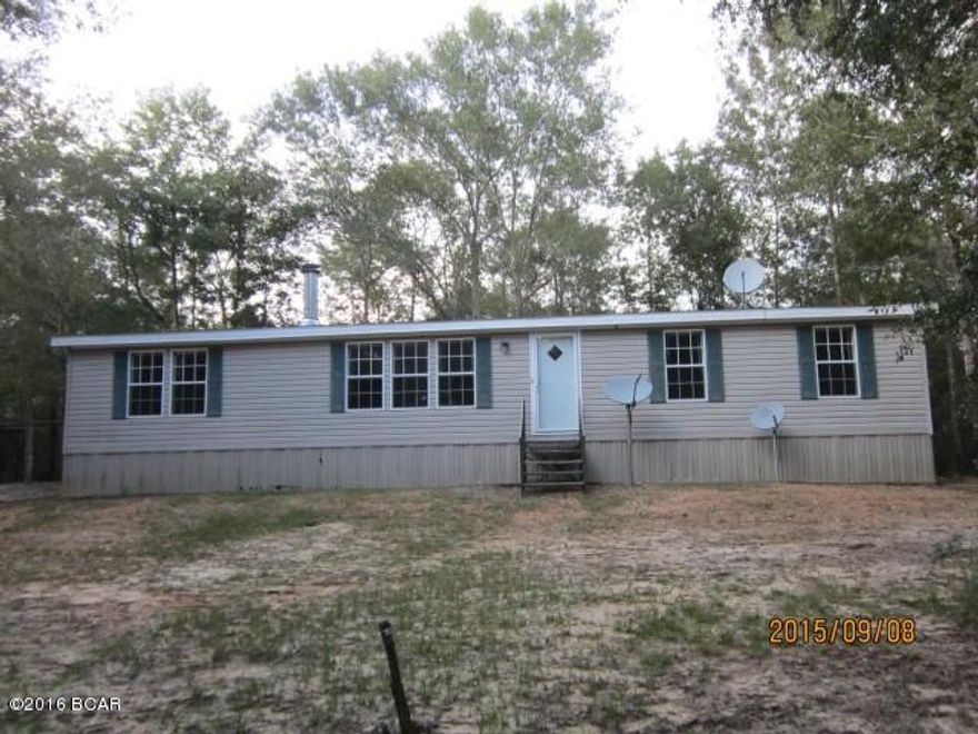 This 40 acre wooded tract is located in NW Holmes County about 2.5 miles South of the Alabama Line in the Leonia Community. The residence is a 2007 Doublewide Mobile Home in excellent condition, 1512 square feet living space, 3 bedroom, 2 bath, with a bonus room that could be a 4th bedroom with addition of closet. Renovations have been completed which include replacing vinyl flooring in bonus room, additional bedrooms, kitchen dining, and bathroom; other work included a door replacement, wall repair, and repainting one bedroom, replacement of light fixture, repairing skirting. Home will need a stove and refrigerator to be move-in ready. This property would make a dandy hunting camp with this spacious mobile home and 40 wooded acres in rural area. John Lane runs across property for East to West and the majority of the acreage is North of the roadway with a smaller portion to the South.  This is a sloping property, mostly high and dry and very isolated.  If you like privacy this is the property for you.  Homesteps Financing is available.  Sold With​​‌​​​​‌​‌​​​​‌​​‌​​​​‌‌ repairs.